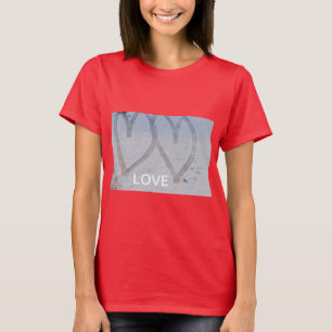 imprint of two hearts drawn in the snow on T-shirt