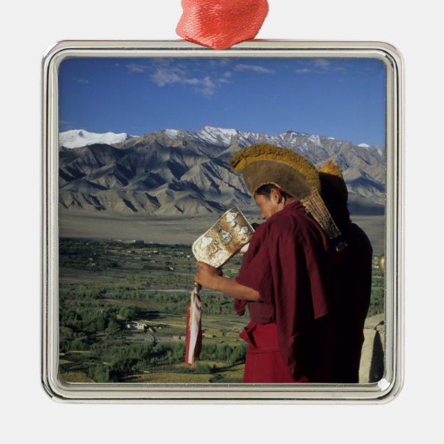 India, Ladakh, Thikse. Buddhist monk blows Metal Tree Decoration (Front)
