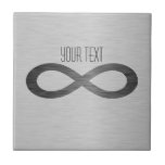 Infinity Symbol On Faux Metal Texture by STaylor Tile<br><div class="desc">Infinity symbol on brushed metal texture ceramic tile. Delete or change sample text,  font,  font colour,  font size to your choice. Images can be rotated,  deleted or re-sized. Images Copyright © Shirley Taylor. All Rights Reserved.</div>