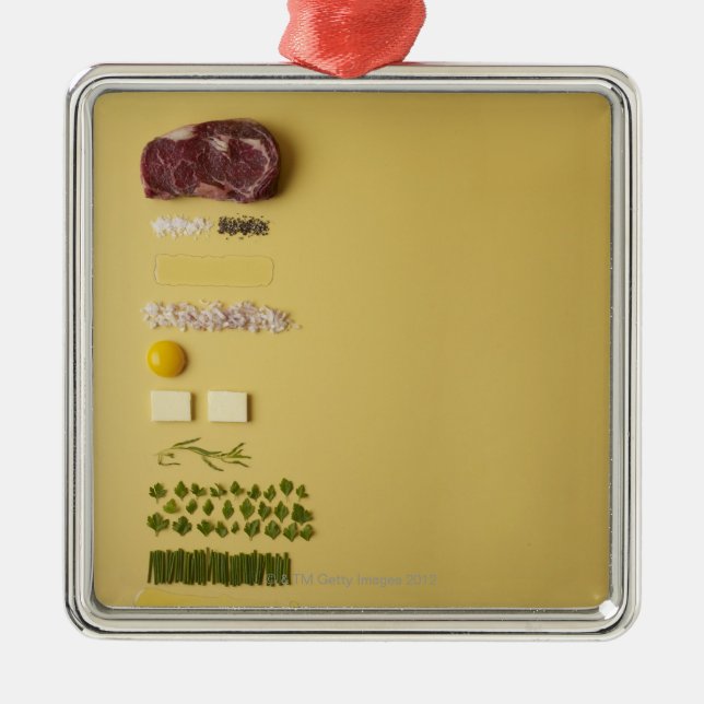 Ingredients for steak tartare on yellow metal tree decoration (Front)