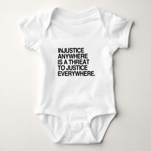 INJUSTICE ANYWHERE IS A THREAT TO JUSTICE -.png Baby Bodysuit
