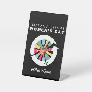 International Women’s Day 2026 Give To Gain Pedestal Sign