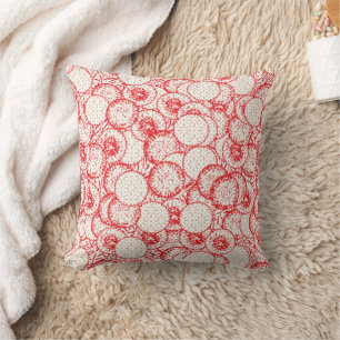 Intricate textile design featuring red, gold, and  cushion