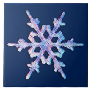 Iridescent snowflake on dark blue tile
