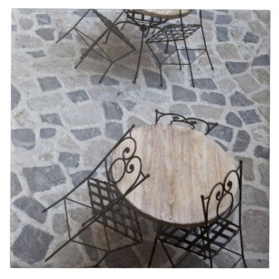 Italy, Sardinia, Castelsardo. Cafe tables. Tile