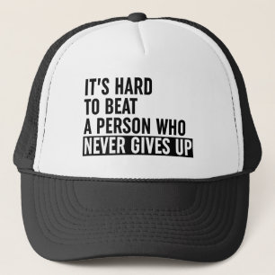 It's Hard To Beat A Person Who Never Gives Up Trucker Hat