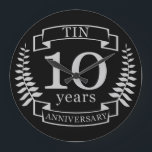 Ivory Traditional wedding anniversary 10 years Large Clock<br><div class="desc">A design to celebrate 10 years of marriage. This design has a Grey / silver (the traditional colour for this anniversary) coloured laurel design on a black background. Tin is the traditional gift for this occasion. The text reads Tin 10 years anniversary. A romantic design to celebrate your 10th year...</div>
