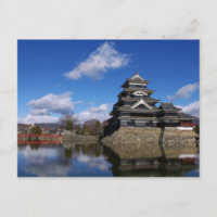 Japanese Castle surrounded by blue castle moat
