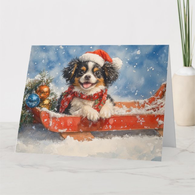 Japanese Chin Dog in Sledge Let it Snow Christmas Card (Front)