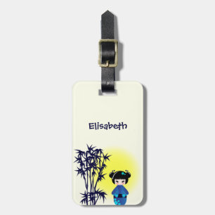 Japanese kokeshi doll at bamboo during sunrise luggage tag