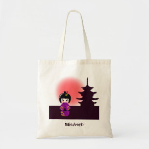 Japanese kokeshi doll at temple during sunset tote bag