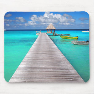 Jetty with boats in a tropical lagoon mouse mat