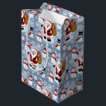 Jolly Santa Claus and Snowmen Christmas Pattern Medium Gift Bag<br><div class="desc">Bring the festive cheer to your holiday decor with this delightful Christmas pattern featuring a jolly Santa Claus carrying a sack full of gifts and adorable snowmen in cosy winter scarves and hats. Set against a whimsical backdrop of snowflakes, this design captures the magic of the holiday season and adds...</div>