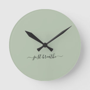 Just breathe green elegant script yoga  round clock