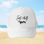 Just Chill - Edición Relax Trucker Hat<br><div class="desc">Do you love to chill and have fun? Then you need this awesome cap with the “Just Chill” design. This cap is white on the front and black on the back, with a mesh trucker style for breathability. On the front, there’s a black print that shows a person relaxing and...</div>
