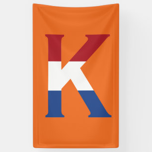 K Monogram overlaid on NLD flag on or bnrcnt Banner