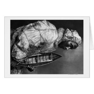 Kayaker wearing water-proof jacket with toy boat