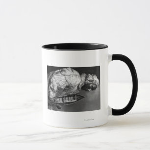 Kayaker wearing water-proof jacket with toy boat mug