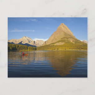 Kayaking in Swiftcurrent Lake at sunrise in the Postcard
