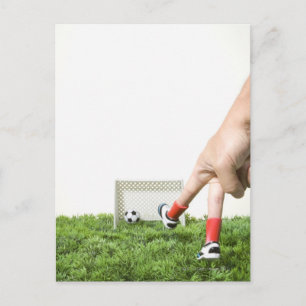 Kicking a soccer ball with finger imitating postcard