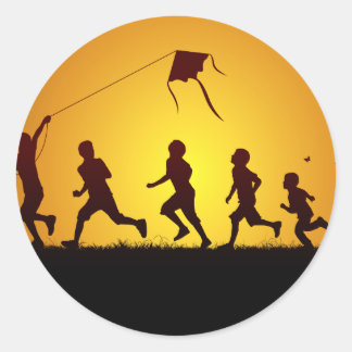 Kids flying a kite classic round sticker