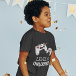 Kids Video Gaming T-Shirt<br><div class="desc">These cool gamer tshirts featuring two gaming control pads over a black background,  with playful text that reads "LEVEL 6 UNLOCKED" and "THEIR NAME AND AGE". All font styles and colours can be changed by clicking on the customise further link after personalising.</div>