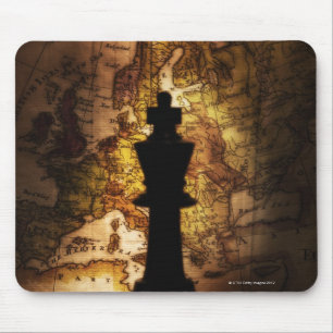 King chess piece on old world map mouse mat