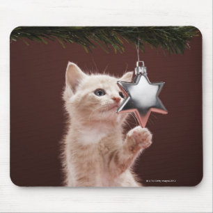 Kitten pawing Christmas decoration on tree Mouse Mat