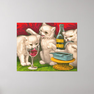 Kittens drinking and eating sardine fish canvas print