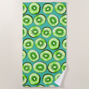 Kiwi slices on turquoise beach towel