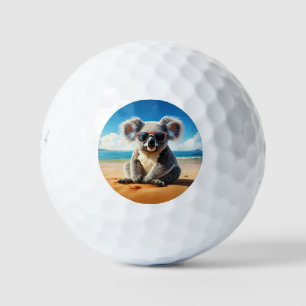 Koala on a sandy beach golf balls