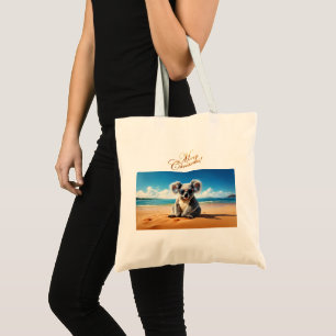 Koala on a sandy beach Merry Christmas Tote Bag