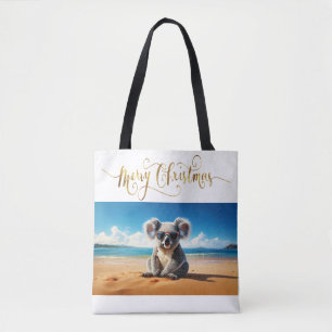 Koala on a sandy beach Merry Christmas Tote Bag