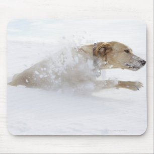Labrador retriever running through deep snow mouse mat