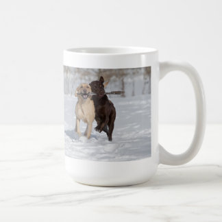Labrador Retrievers playing in the snow. Coffee Mug