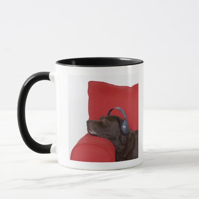 Labrador wearing headphones lying on sofa mug (Left)