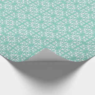 Lacy cutwork - white over seafoam green wrapping paper