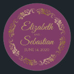 Lacy Gold Filigree Elegant Cassis Purple Wedding Classic Round Sticker<br><div class="desc">These elegant wedding stickers feature fancy gold script text on a cassis purple,  magenta,  or berry coloured background with a lacy gold faux foil floral border. The text is fully customisable and contains the wedding couple's names and wedding date. Great as favour tags or envelope seals!</div>