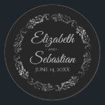 Lacy Silver Filigree Elegant Black Wedding Classic Round Sticker<br><div class="desc">These elegant wedding stickers feature fancy pale grey script text on a black background with a lacy silver faux foil floral border. The text is fully customisable and contains the wedding couple's names and wedding date. Great as favour tags or envelope seals!</div>