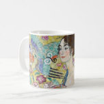 Lady with A Fan, Gustav Klimt Coffee Mug<br><div class="desc">Gustav Klimt (July 14, 1862 – February 6, 1918) was an Austrian symbolist painter and one of the most prominent members of the Vienna Secession movement. Klimt is noted for his paintings, murals, sketches, and other objets d'art. In addition to his figurative works, which include allegories and portraits, he painted...</div>