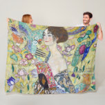 Lady with A Fan, Gustav Klimt Fleece Blanket<br><div class="desc">Gustav Klimt (July 14, 1862 – February 6, 1918) was an Austrian symbolist painter and one of the most prominent members of the Vienna Secession movement. Klimt is noted for his paintings, murals, sketches, and other objets d'art. In addition to his figurative works, which include allegories and portraits, he painted...</div>