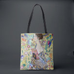 Lady with A Fan, Gustav Klimt Tote Bag<br><div class="desc">Gustav Klimt (July 14, 1862 – February 6, 1918) was an Austrian symbolist painter and one of the most prominent members of the Vienna Secession movement. Klimt is noted for his paintings, murals, sketches, and other objets d'art. In addition to his figurative works, which include allegories and portraits, he painted...</div>
