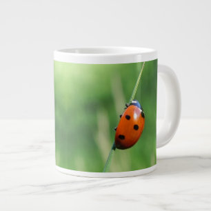 Ladybug on a blade of grass large coffee mug