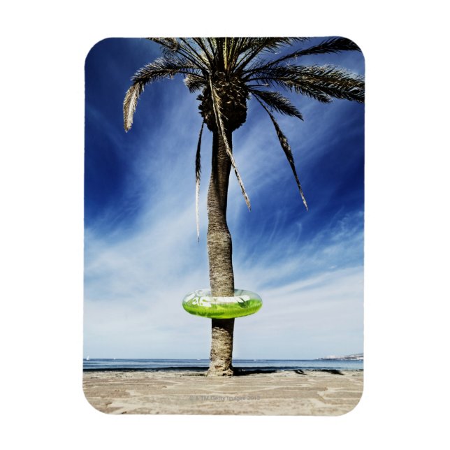 Large palm tree on a sandy beach with inflatable magnet (Vertical)