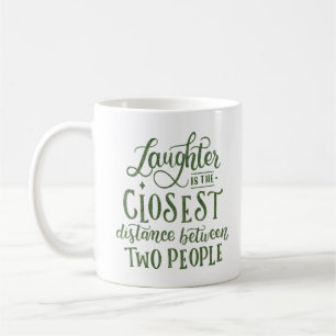 LAUGHTER IS THE CLOSEST DISTANCE COFFEE MUG