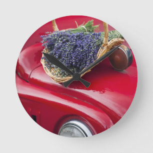 Lavender bunches rest on old farm pickup truck round clock