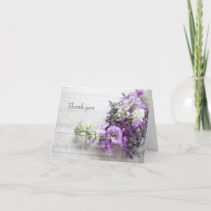 Lavender-coloured flowers on old music thank you