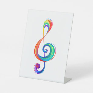 Layered rainbow treble clef pedestal sign