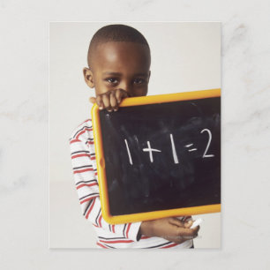 Learning arithmetic. 4-year-old boy holding a postcard