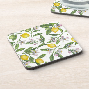 Lemon branches with blossoms and fruit on white coaster